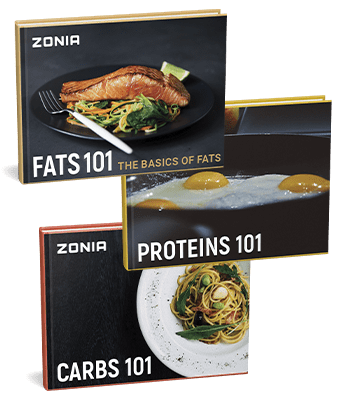 A set of three Zonia nutrition guidebooks titled "Fats 101" (featuring salmon), "Proteins 101" (with fried eggs), and "Carbs 101" (showing pasta).